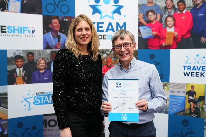 Anuschka Evans, Style Brands, Robin Pointon, Go Travel Solutions pose with award certificate. Modeshift display stand with logo in background.