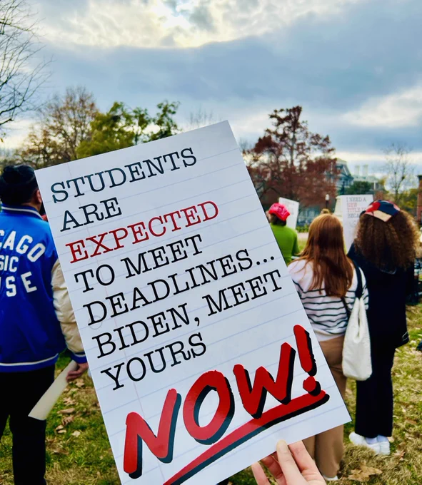 A sign outside the White House says "Students are expected to meet deadlines...Biden, meet yours now!"