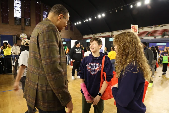 Chancellor Ferebee speaks with two students from Eliot-Hine Middle School.