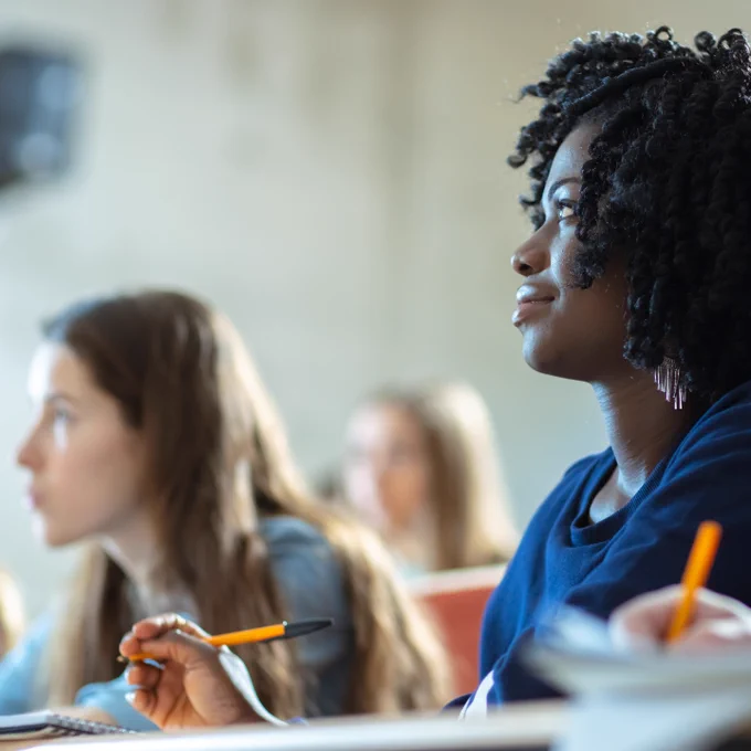 Close-up of a Black Female Student Sitting Among Her Fellow Students in the Classroom