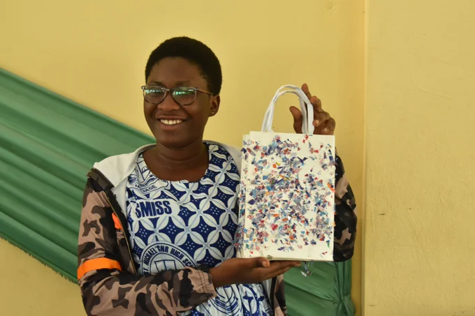 Student, Amanda of St Michael's SHS, flaunting her paper gift bag made with an old calendar. Cool, isn't it?