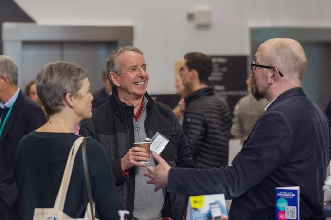Three people networking with coffee.