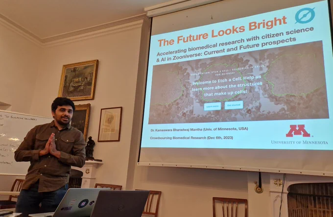 Researcher standing in front of a screen with a slide entitled "The future looks bright"