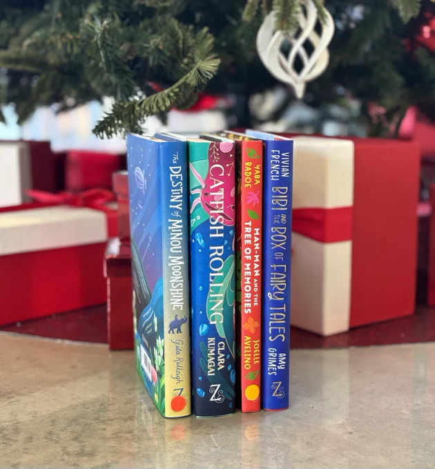 A photograph of the four books you can win in the giveaway which are The Destiny of Minou Moonshine, Catfish Rolling, Man-Man and the Tree of Memories, Bibi and the Box of Fairy Tales.