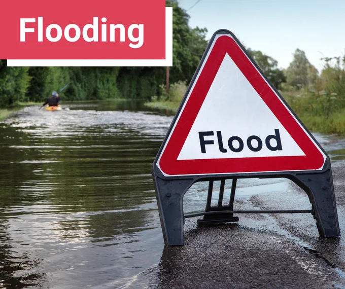 flooded road with flood sign
