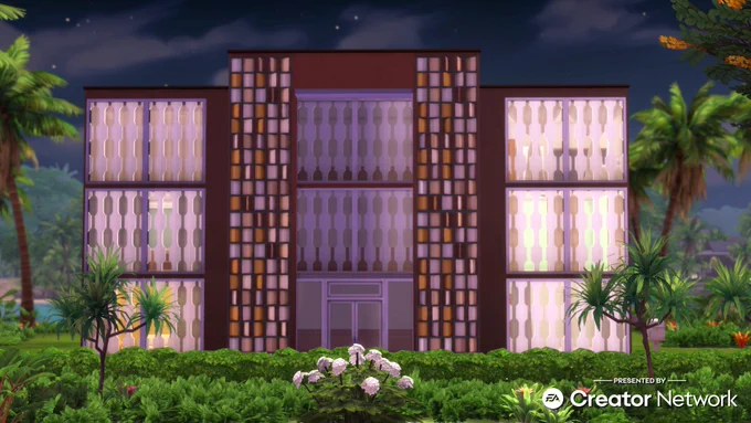 A mid-century modern style apartment building in The Sims 4: For Rent expansion pack. There's shrubs and palm trees all around, and it's nighttime, with stars in the background.