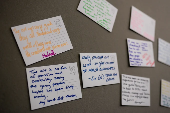A photo showing cards with people's reflections and thoughts about the art. 