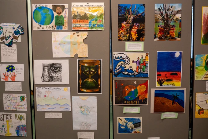 A photo of children's artwork on the wall at the Get Creative 4 Climate Justice exhibition at Parliament. 