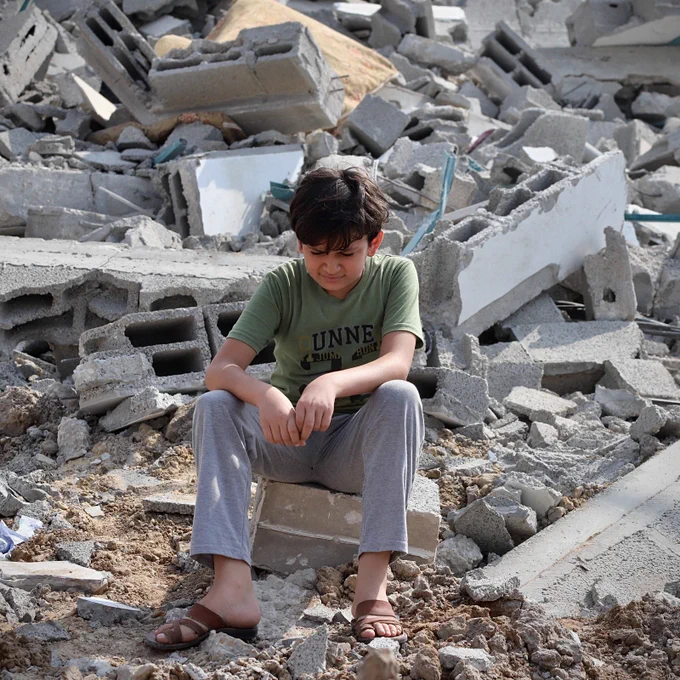 A child next to the ruins of a building in Gaza City.

Photo: © Doaa Albaz /Middle East Images via AFP 10/08/2023