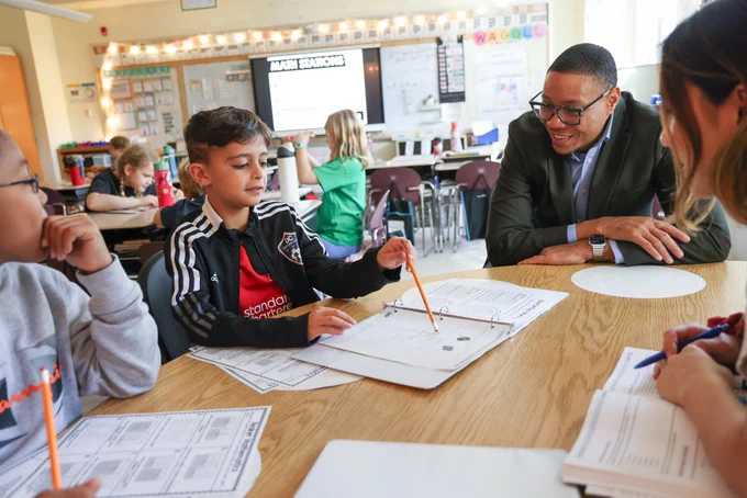 Chancellor Ferebee joins a small group math lesson.