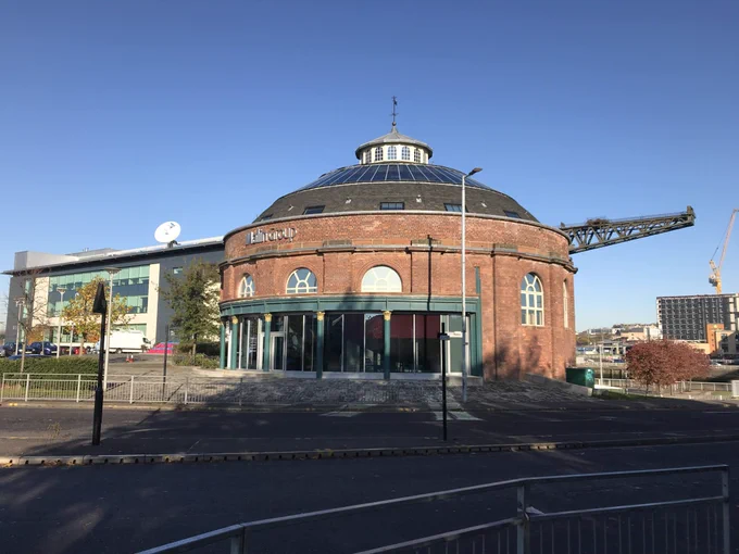 This is the South Rotunda at 100 Govan Road, Glasgow. With a bit of Glasgow City Heritage Trust funding, it was saved from dereliction and brought back into use as the headquarters for Malin Group but was originally built between 1890-5 over the entrance to the 3 tunnels under the Clyde. The red brick rotunda, with Scottish slate roof, and cast iron Corinthian columns holding up a huge steel beam for the vehicular entrance, is a well known landmark on the Clyde. During the Glasgow Garden Festival it was used as an ice cream parlour. It was then used as  the “Dome of Discovery”, funded by Glasgow City Council and BP Exploration to celebrate the scientific and industrial culture of Glasgow . The building was subsequently used by the National Theatre of Scotland, as a pop-up arts venue, forming a key part of the  Glasgow’s 2014 Cultural Programme and Commonwealth Games. The Malin Group acquired the rotunda in 2015, working over 3 years to bring it back to its former glory.