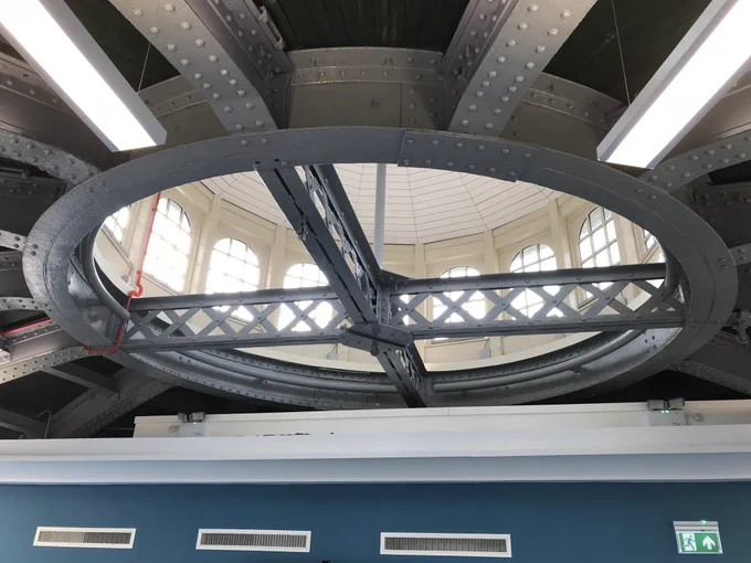 This photograph shows the detail of the white painted lattice steel beams and circular steel ring beam which supports the cupola at the top of the domed Scottish slate roof of the South Rotunda. The building at 100 Govan Road is now the headquarters for Malin Group but was originally built between 1890-5 over the entrance to the 3 tunnels under the Clyde