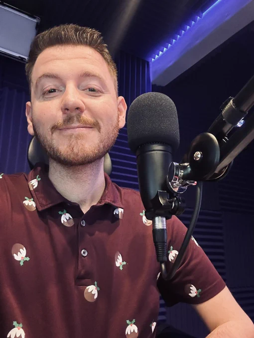 Selfie of Ross in the radio studio, wearing a Xmas pudding tshirt
