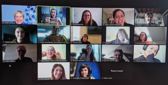A screenshot of 15 people in a zoom meeting, smiling