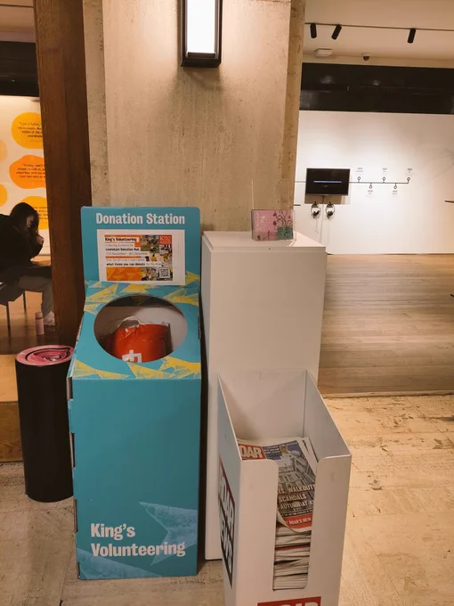 image of the donation box (next two the newspaper stand) at the main entrance to the Arcade, Bush House.