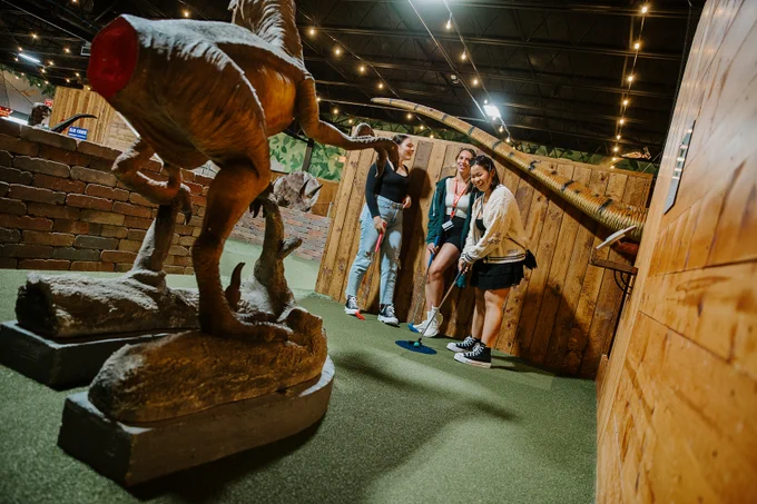 Students play mini golf at Prehistoric Putt