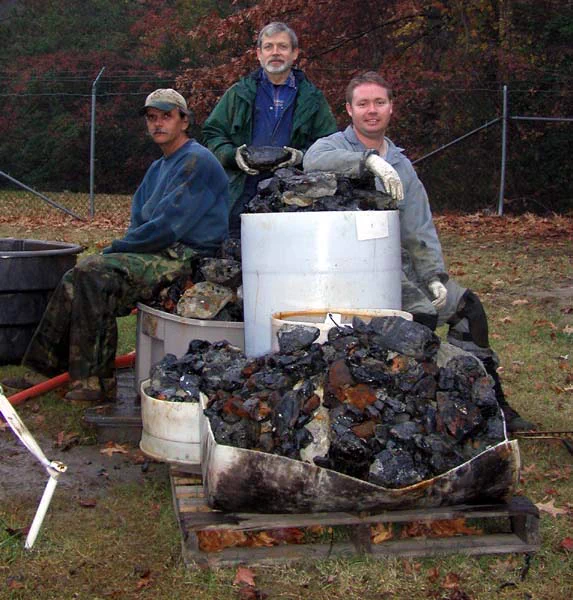 (l to r) Jeff Johnston, Dr. John Broadwater, and Tane Casserley with some of the coal that they have removed during the course of the turret excavation. Click image for larger view and detailed explanation.

