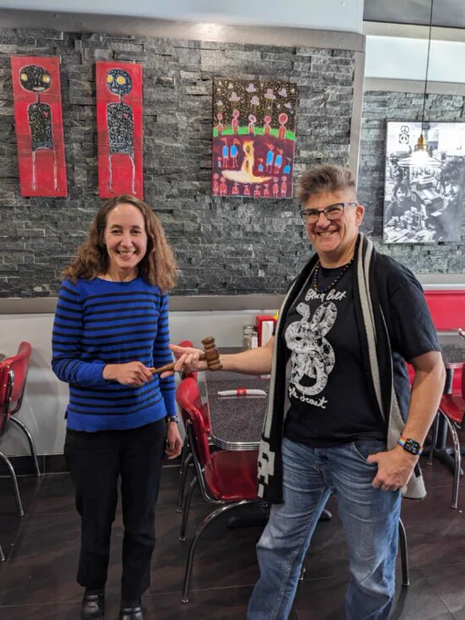 Laurie Neuerburg handing the ILA/ACRL gavel to Lisa Martincik.