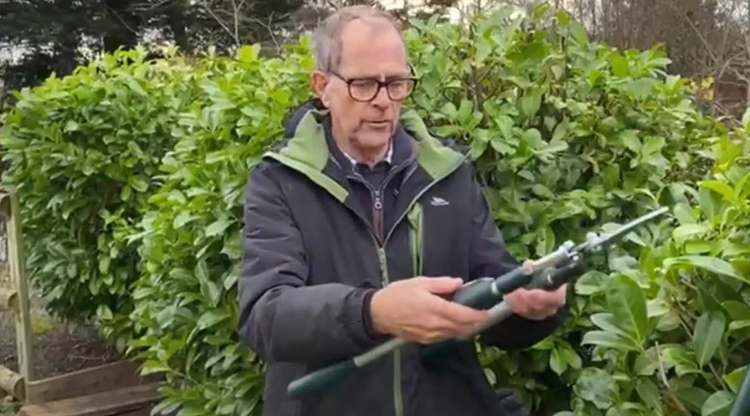 Ken is holding a pair of Bulldog lopping shears. 
