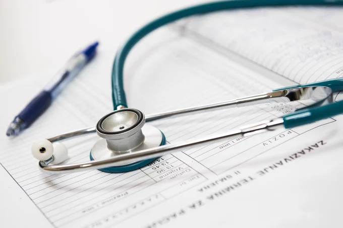 A doctor's stethoscope and patient notes