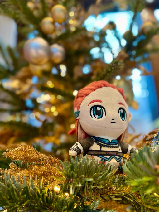 Photo of an Aloy plushie sitting on a Christmas tree