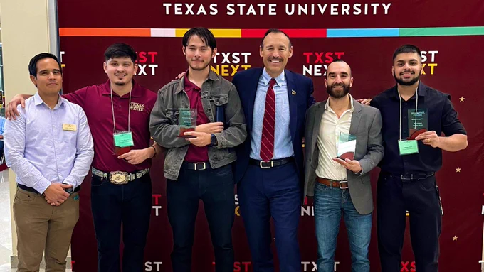 President Damphousse with student engineering team