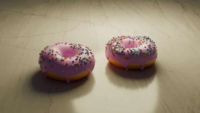 Image shows a marble surface with two donuts on it.