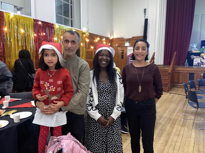 Image of Cllr Maria Kay with a family at Lambeth's Festive Jam 