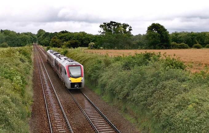 Train travelling through lush countryside