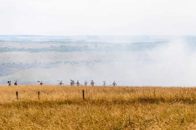 Photo of fields with smoke covering part of them