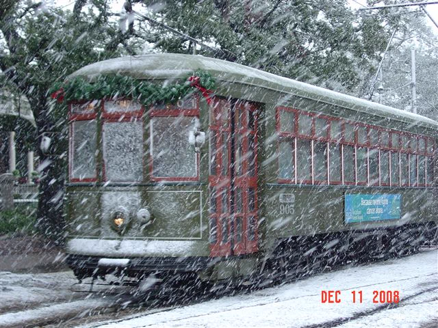 Image of snow falling in New Orleans on December 11, 2008 with a trolley in the background.