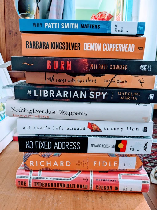 A stack of books: the Underground Railway, The Book of Roads and Kingdoms, No Fixed Address, All That's Left Unsaid, Nothing Ever Just Disappears, The Librarian Spy, We Come With This Place, Burn, Demon Copperhead, Why Patti Smith Matters. 