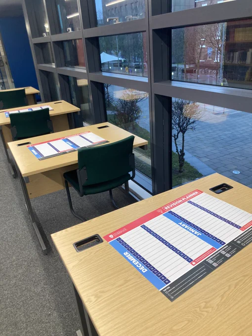 Image of KnowHow revision planners on desks in the Sydney Jones Library