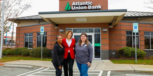 Teammates in front of bank branch. 