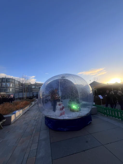 Giant snow globe in front of stalls under a blue sky in st Mungo’s square on western campus at UofG