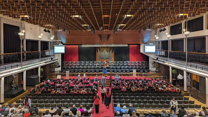 Photo of Lancaster University's Great Hall filled with graduating students and guests 