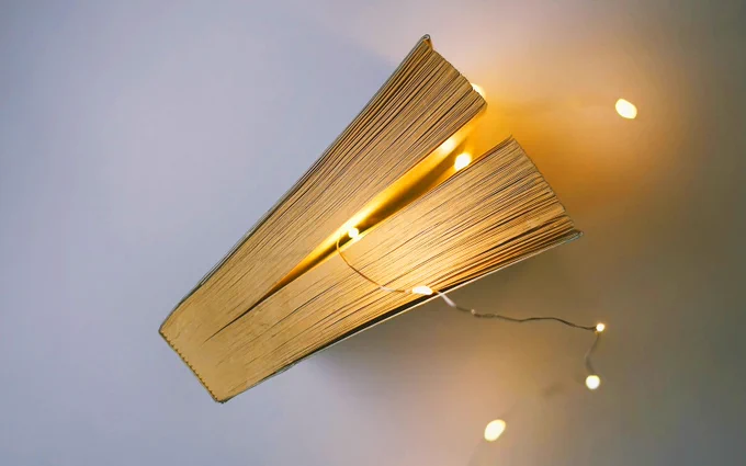 photo of a book with a string of lights running through the pages