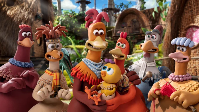 An animation of a group of smiling chickens, huddled together gazing at a baby chick.