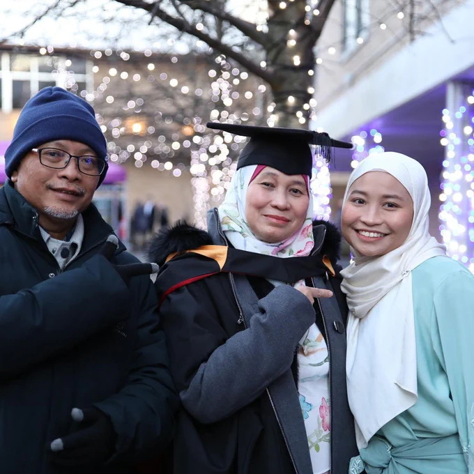 Photo of a graduating student with guests