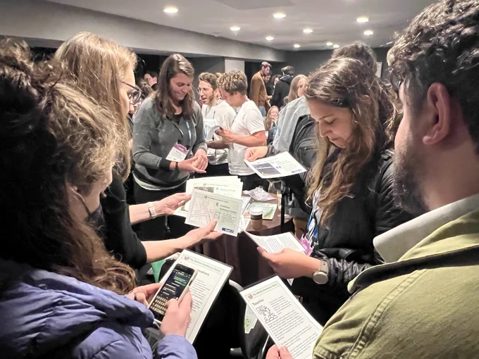 People gathered around a table working through a game together