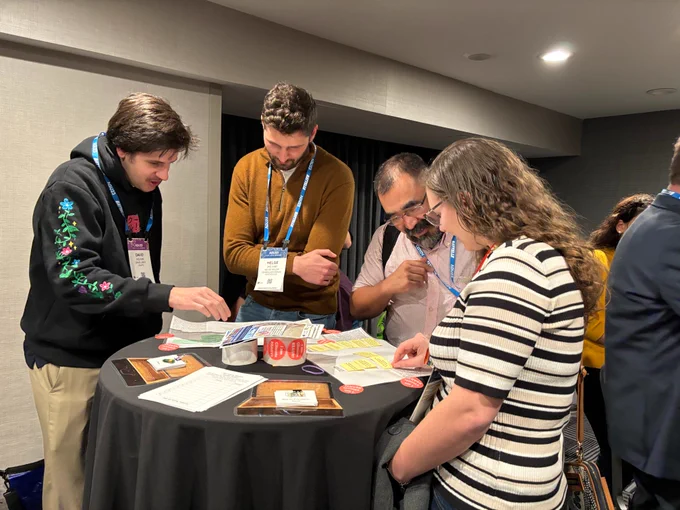 People gathered around a table working through a game together