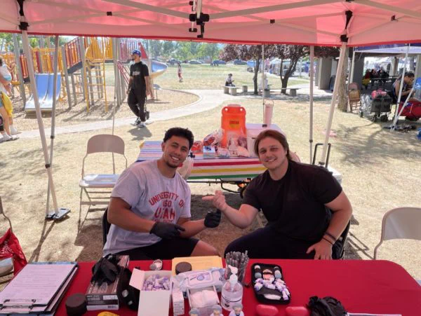 Jacob Taloa (L) during a diabetes screening community outreach event.