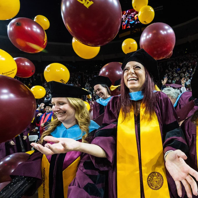 Students celebrate as balloons drop from the ceiling of ASU’s Desert Financial Arena as ASU’s graduate commencement ceremony ends.