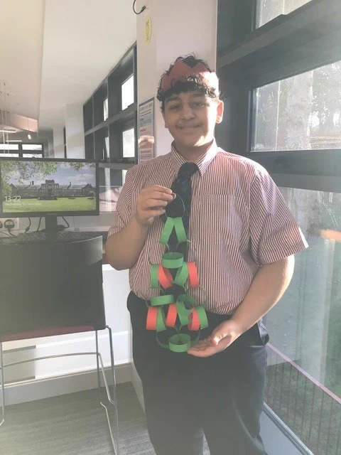 Picture of a person holding a homemade Christmas tree decoration.