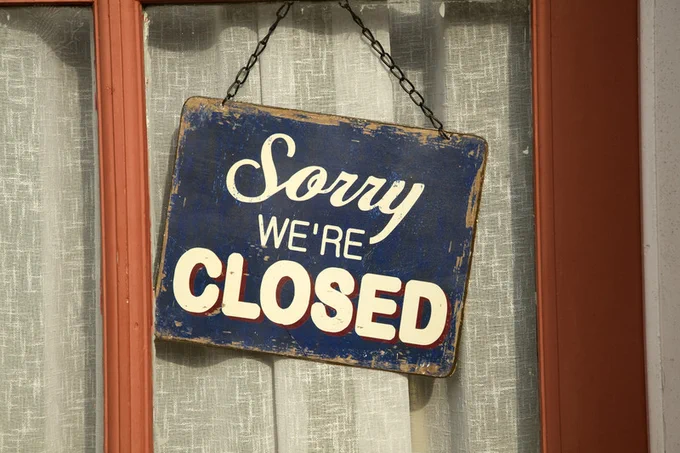 Old fashioned 'Sorry we're Closed' sign in window of closed down village shop. The image and information shown here are provided by © Universal Images Group