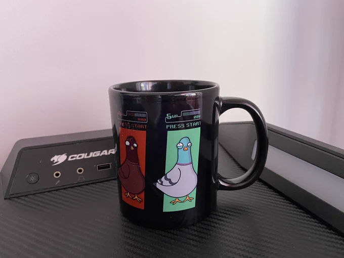 Image of a black cup with three pigeons on the left and center