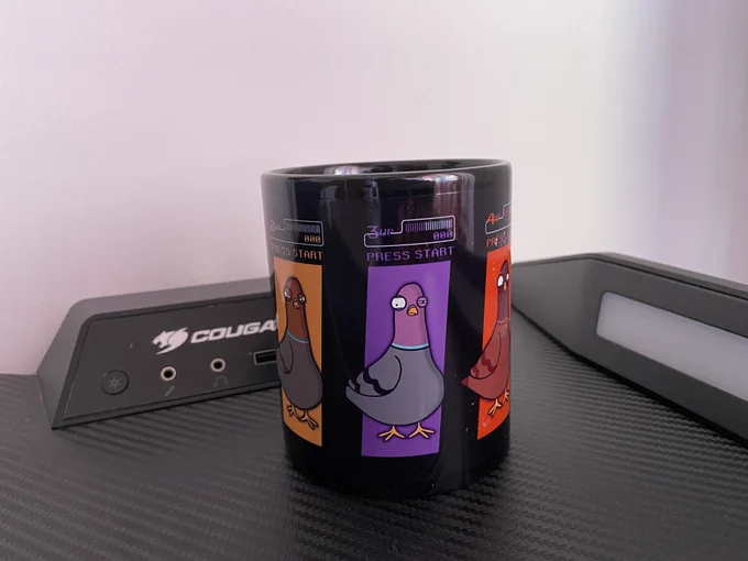 Image of a black cup with three pigeons on the left, center and right