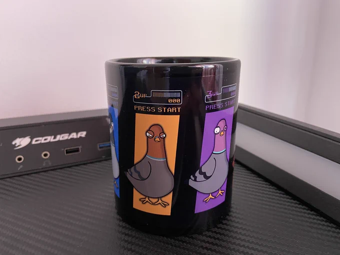 Image of a black cup with three pigeons on the left, center and right