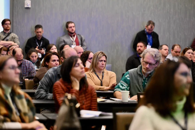 Breakout session attendees listening to presentation speakers