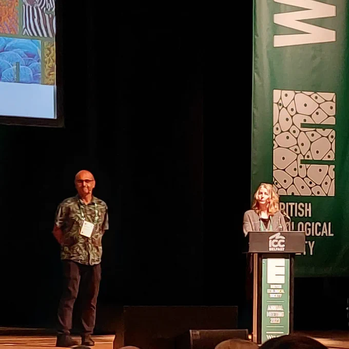 Two people standing on the stage at the British Ecological Society annual meeting